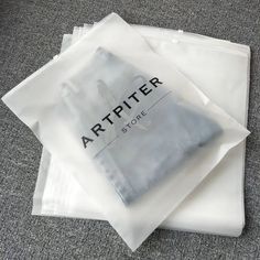 four white bags sitting on top of each other in the middle of a carpeted floor