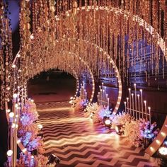 an archway decorated with lights and flowers