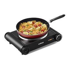 an electric skillet with pasta and vegetables cooking on the burner, in front of a white background