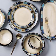 a table topped with plates and silverware next to a knife, fork and spoon