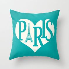 a pink pillow with the word paris in a heart shape and the eiffel tower