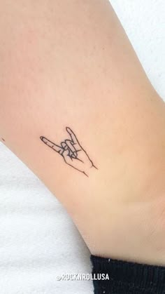 a small tattoo on the wrist of a woman