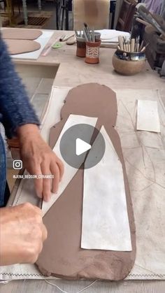 a person is making something out of clay