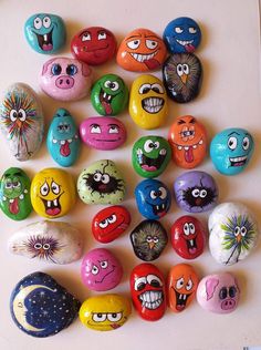 many different colored rocks with faces painted on them