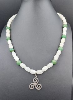 This Necklace features a Stainless Steel Triskele with Oval Quartz and Round Green Aventurine beads/ The Triskele symbol can be thought to represent motion as all three arms are positioned to make it appear as if it is moving outwards from its center. Movement is the motion of action, cycles, progress, revolution and competition. Some of these connotations include: life-death-rebirth, spirit-mind-body, mother-father-child, past-present-future, power-intellect-love and creation-preservation-destruction to name but a few. Quartz has the unique property of being "programmable", meaning you can infuse it with your intention and then it will amplify it, working on your behalf to manifest it in the world. Green Aventurine is known as the "Lucky Talisman" or "Stone of Opportunity" for its good lu Lobster Claws, Quartz Beads, Green Aventurine, Mind Body, Lobster Claw, Favorite Jewelry, Beaded Necklace, Jewelry Necklaces, Accessory Gift