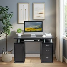 a desk with a computer on it in front of a window and potted plant