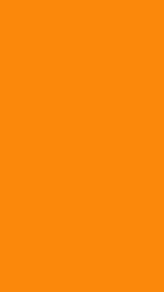 two giraffes standing next to each other on an orange background