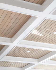 the ceiling is covered with wooden planks and white paint on it's sides