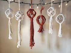 several ornaments hanging from a string on a wall