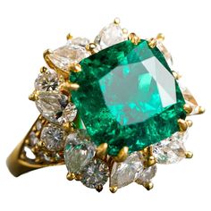 The Colombian Emerald has always been the most desirable of all the emeralds and this one is no exception. Crafted in 18k yellow gold featuring one square cushion Colombian emerald weighing 8.39ct and has minor to moderate clarity enhancement. The center stone is surrounded by eight pear shaped diamonds and twenty four round diamonds weighing approximately 5.25 cttw with F/G color and VS clarity. Ring size 8. The emerald has a very deep and rich color and comes with an AGL report. This ring is a Emerald And Diamond Ring, Diamond Cocktail Ring, Emerald Diamond Ring, Sparkly Jewelry, Colombian Emeralds, Diamond Cocktail Rings, Jewel Box, Pear Shaped Diamond, Emerald Jewelry