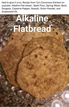 two flatbreads sitting on top of a glass plate