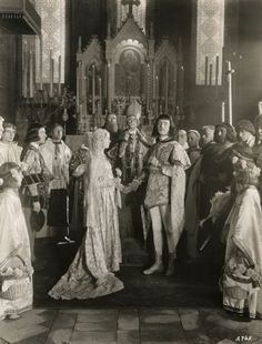 an old black and white photo of people dressed in medieval clothing standing around the alter