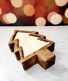 a wooden candle holder sitting on top of a table