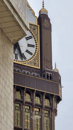 a large clock on the side of a building with gold trim around it's sides