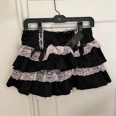 Nwt - Widow X Dolls Kill The Cake Topper Mini Skirt - M This Black And Pink High-Waisted Mini Skirt Has A Tiered Non-Stretch Construction, Contrast-Colored Baby Pink Lace Trim, Black Bow Appliques, And A Back Zip Closure. Perfect Pastel Goth Piece!! Measurements: Waist - 30” Length - 13.5” Sold Out Online!! #Pastelgoth #Kawaii #Pastelpunk #Coquette #Dollette #Cutecore #Cosplay #Egirl Pink And Black Mini Skirt, Pink And Black Goth Outfit, Cutecore Cosplay, Cutecore Skirt, Pink And Black Coquette, Pink Goth Outfits, Pastel Goth Skirt, Pink And Black Goth, Hannah Marin