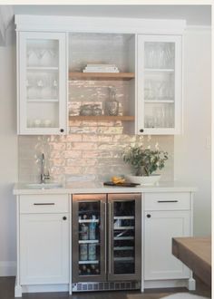 a kitchen with white cabinets and stainless steel appliances in the center, along with an open refrigerator