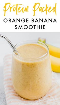 an orange banana smoothie in a glass with a spoon