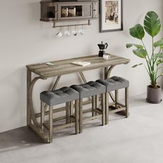 a table with four stools next to it and a potted plant in the corner