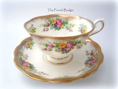 an antique tea cup and saucer decorated with flowers