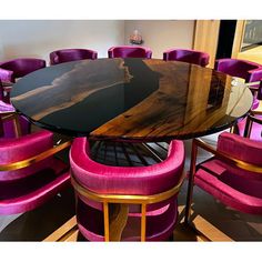 a dining room table with purple chairs around it