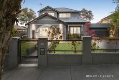 a house with a fence in front of it