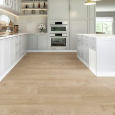 a large kitchen with white cabinets and wood flooring, along with open shelving