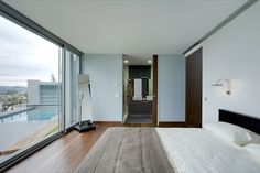 a bedroom with a large bed next to a sliding glass door