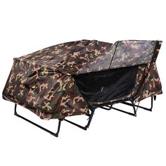 an outdoor camping cot with camouflage print cover