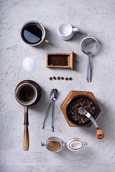 an overhead view of coffee and kitchen utensils on a table with spoons