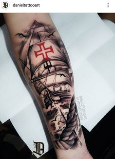 a man's arm with a ship on it