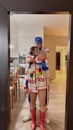 a man and woman standing next to each other in front of a mirror with the words wonder written on it