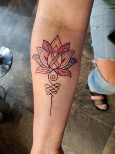 a woman's leg with a tattoo on it that has a flower in the middle