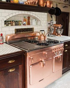 an old fashioned copper stove in a kitchen