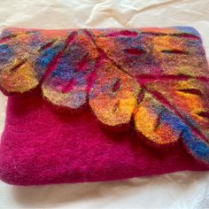 a colorful felted purse with leaves on it