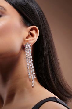 Adorn yourself with elegance with these exquisite long Diamond danglers, featuring three strings of shimmering faux diamonds against a pristine white finish. A true statement piece, they exude sophistication and add a touch of ravishing allure to any ensemble, perfect for elevating your look with timeless charm. Finish: Rhodium Material: Brass, Faux Diamonds Color: White Size: One Size Closure Type: Push Back Box Contains: 1 Pair of Earrings Danglers Earrings Diamond, Long Diamond Earrings, Diamond Danglers, Hand Jewelry Rings, Chain Braid, Diamond Earrings For Women, Artificial Jewelry, White Diamond Earrings, Dangler Earrings