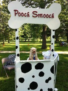 a dog in a booth made to look like a pooch smooch