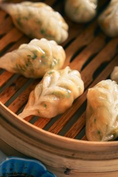 some dumplings are sitting on a wooden tray