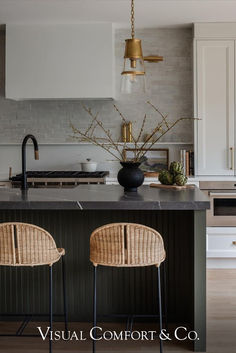 two wicker stools sit in front of the kitchen island