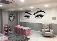 a room with two chairs and an eye mural on the wall above it's eyes