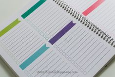 a spiral bound notebook with colorful arrows on the cover and lined paper attached to it