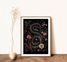 a snake is on the wall next to a vase with flowers