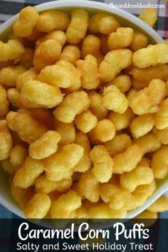 a bowl filled with corn puffs sitting on top of a checkered table cloth