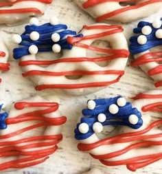 red, white and blue decorated doughnuts are arranged in the shape of an american flag