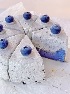 a white cake with blueberries on top