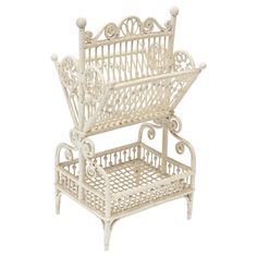 a white wicker chair with an open shelf on the top and bottom, against a white background