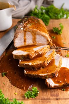 sliced pork with gravy on a cutting board