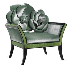 a green chair with a flower on it's back and arm rests in front of a white background