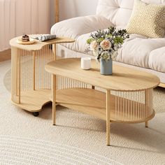 two wooden tables sitting on top of a rug next to a white couch and table