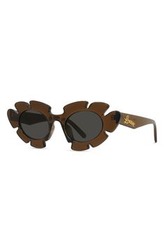 A floral-inspired silhouette enhances the delicate glamour of these Italian-made sunglasses designed in collaboration with the boutique Paula's Ibiza. 47mm lens width; 20mm bridge width; 140mm temple length 100% UV protection CR-39 lenses Injected plastic Made in Italy Loewe Sunglasses, Brown Sunglasses, The Boutique, 50 Shades, Golden Brown, Designer Sunglasses, Eyewear Sunglasses, Cat Eye Sunglasses, Ibiza