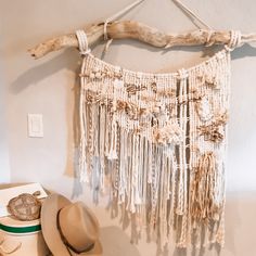 This natural colored macrame wall hanging is an incredibly unique, one of a kind, décor piece that will look wonderful in any area of your home.  Imagine it in your living room, bedroom, bathroom, or anywhere!   Accented with real seashells, silk recycled from saris, and thick chunky rope. Coordinates beautifully with Boho, natural, and whimsical decoration styles.  Get it for yourself for as a great gift! Color:  Natural materials so there may be some discrepancies due to the nature of a natural material as well as different monitor settings. Size:  Width - mount measurements not just the cord Height - may include the highest point of the hanging cord Material: 100% cotton cord Found lake  driftwood Macrame Wall Hanging With Fabric, Sand Wall Hanging, T Shirt Yarn Macrame Wall Hanging, Wall Art For Braiding, Rope And Wood Western Wall Art, Boho Woven Wall Hanging, Mixed Media Macrame Wall Hanging, Hanging Seashells, Beachy Macrame